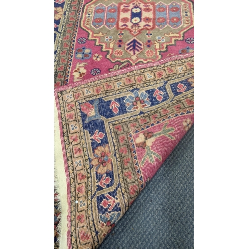 553 - Two handwoven rugs to include a Turkish red ground runner having floral motifs, 300cm x 86cm, the ot... 