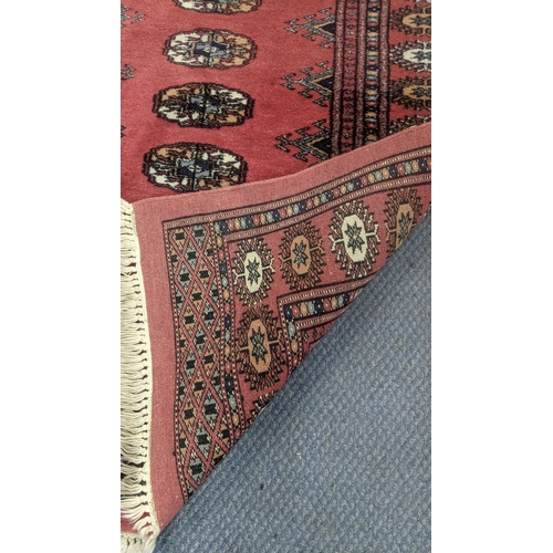 555 - Two handwoven rugs to include an Afghan rug on a red ground with repeating motifs, 205 x 95cm, the o... 