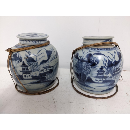 398 - Two Chinese blue and white provincial ginger jars and covers, with remains of bamboo cage surrounds ... 