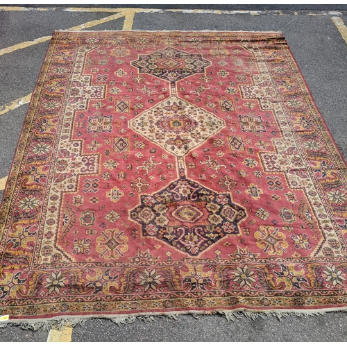 466 - A mid 20th century hand woven Persian style rug, possibly Turkish, three stylized floral central des... 