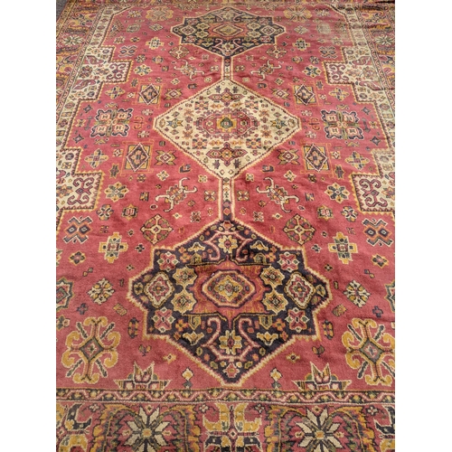 466 - A mid 20th century hand woven Persian style rug, possibly Turkish, three stylized floral central des... 