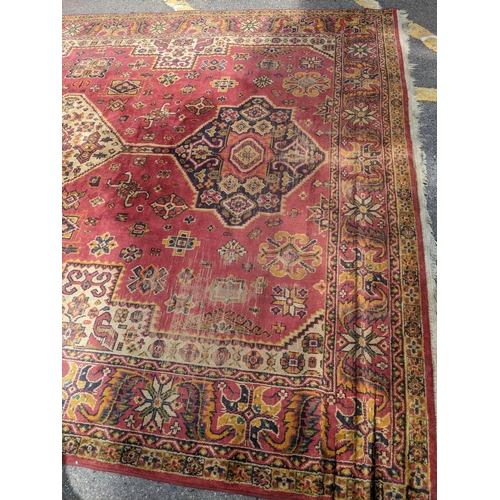 466 - A mid 20th century hand woven Persian style rug, possibly Turkish, three stylized floral central des... 