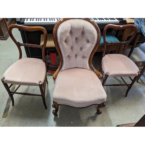 529 - A Victorian mahogany upholstered nursing chair together with two Victorian balloon back bedside chai... 