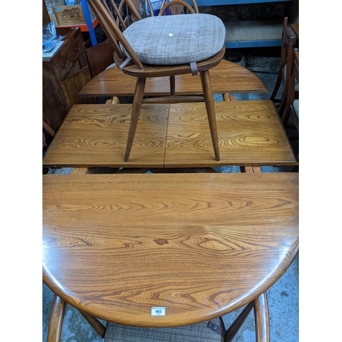 543 - A late 20th century Ercol elm extending dining table with butterfly extending leaf, on pedestal base... 