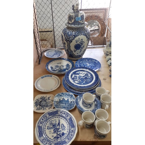 548 - A quantity of Delft and similar blue and white ornaments to include a cow creamer, windmills and a p... 