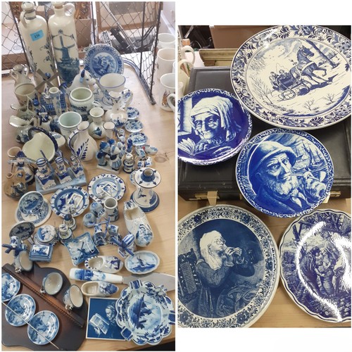 548 - A quantity of Delft and similar blue and white ornaments to include a cow creamer, windmills and a p... 