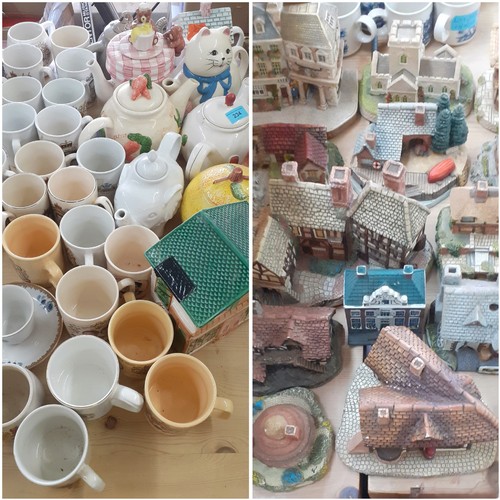 549 - A quantity of novelty teapots, commemorative mugs, wooden models of animals and ornamental buildings... 