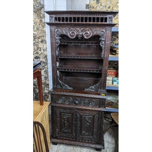 279 - A late 18th century carved oak cabinet with stepped moulded cornice, balustrade decoration, scrolled... 