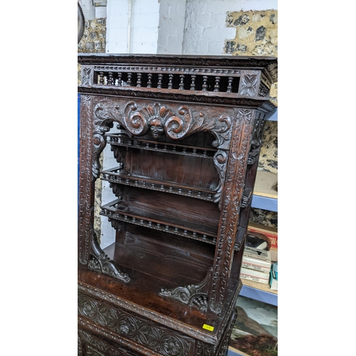 279 - A late 18th century carved oak cabinet with stepped moulded cornice, balustrade decoration, scrolled... 