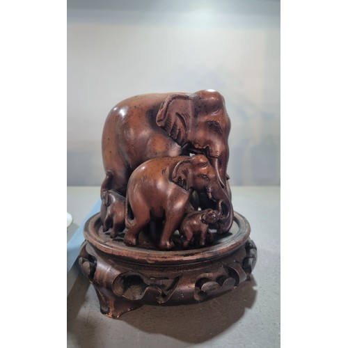 303 - A carved model of a herd of elephants, together with a Chinese stand and Mud Man figure Location:4.1... 