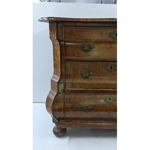 168 - A 18th century continental burr walnut bombe chest of three graduating drawers, having marquetry inl... 