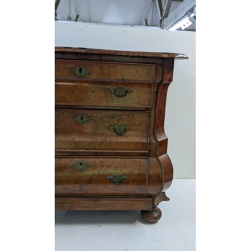 168 - A 18th century continental burr walnut bombe chest of three graduating drawers, having marquetry inl... 