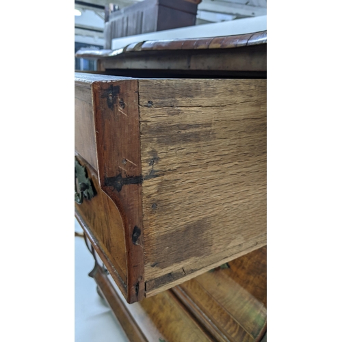 168 - A 18th century continental burr walnut bombe chest of three graduating drawers, having marquetry inl... 