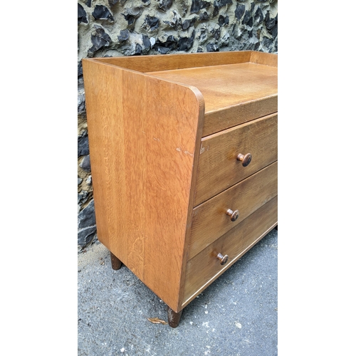 194 - A 1940's Gordon Russell of Broadway, oak three drawer straight front chest of drawers, having a thre... 