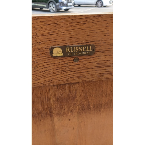 194 - A 1940's Gordon Russell of Broadway, oak three drawer straight front chest of drawers, having a thre... 