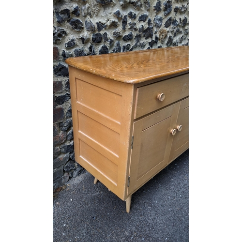 195 - A 1960s Ercol blonde elm and beech sideboard model 351, designed by Lucian Ercolani, having two draw... 