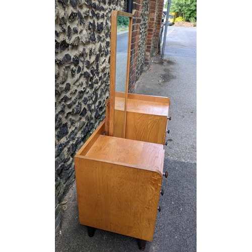 196 - A 1930's Gordon Russell of Broadway, oak dressing table, having a three-quarter gallery surrounding ... 