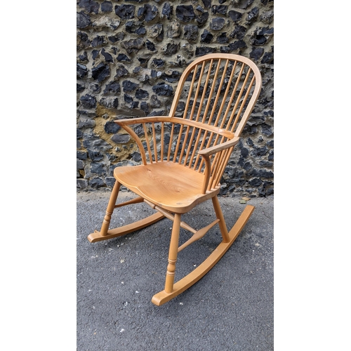 197 - A Stewart Linford Windsor ash, elm and beech stick back rocking chair, in the Ercol style, having a ... 