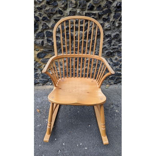 197 - A Stewart Linford Windsor ash, elm and beech stick back rocking chair, in the Ercol style, having a ... 