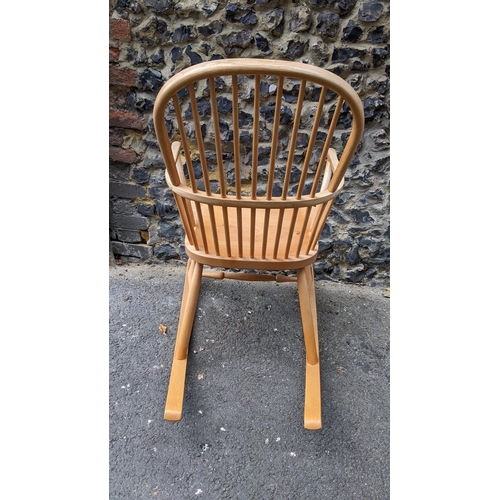 197 - A Stewart Linford Windsor ash, elm and beech stick back rocking chair, in the Ercol style, having a ... 