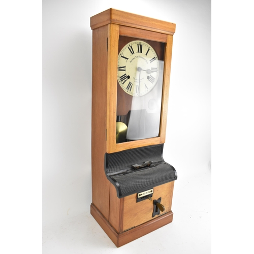 90A - An early/mid 20th century National Time Recorder clocking in clock, in a stained beech case, the cir... 