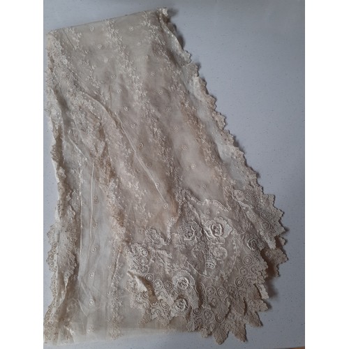 59 - An Edwardian cream lace veil having a button mesh ground with floral embroidered sprays, 24cm wide x... 