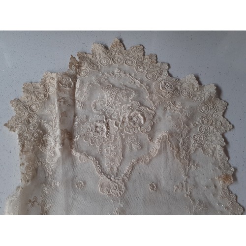 59 - An Edwardian cream lace veil having a button mesh ground with floral embroidered sprays, 24cm wide x... 