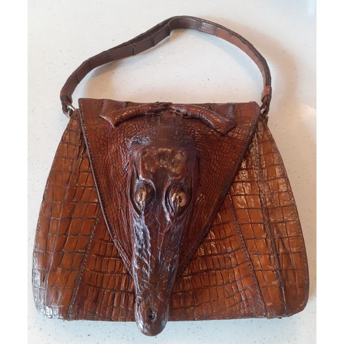 A mid 20th Century brown crocodile skin bag with baby crocodile head and feet to the flap. Location: