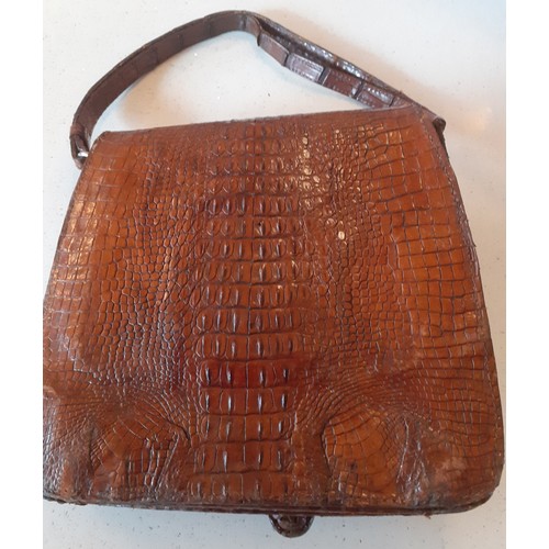 62 - A mid 20th Century brown crocodile skin bag with baby crocodile head and feet to the flap. Location:... 