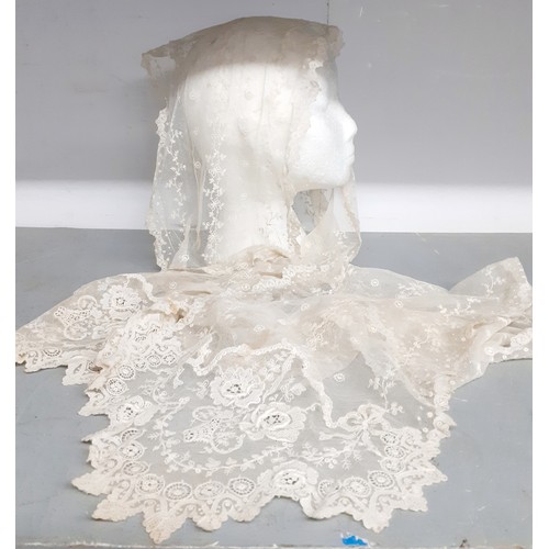 An Edwardian cream lace veil having a button mesh ground with floral embroidered sprays, 24cm wide x 25cm long. Location:
Condition:2 small holes, a few small age-related stains-see additional photos