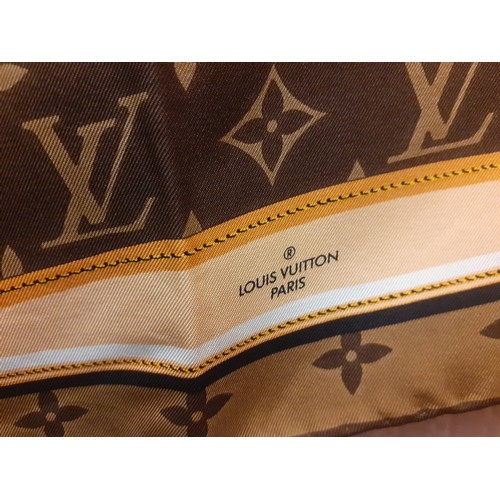 2 - Louis Vuitton- A brown LV monogram silk scarf with belt and chain design having hand rolled edges to... 