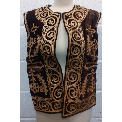 34 - A Turkish Ottoman waistcoat having a brown velvet ground with elaborate gold metallic braid with ima... 