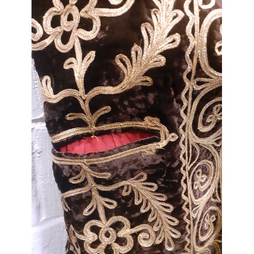 34 - A Turkish Ottoman waistcoat having a brown velvet ground with elaborate gold metallic braid with ima... 