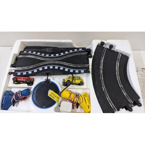 103 - A Scalextric and track to include two Mini Clubman's 1275 GT's one red and the other yellow, in the ... 