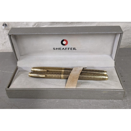 11 - Four pens to include a boxed 14ct gold plated Shaefer fountain and ball point pen set together with ... 