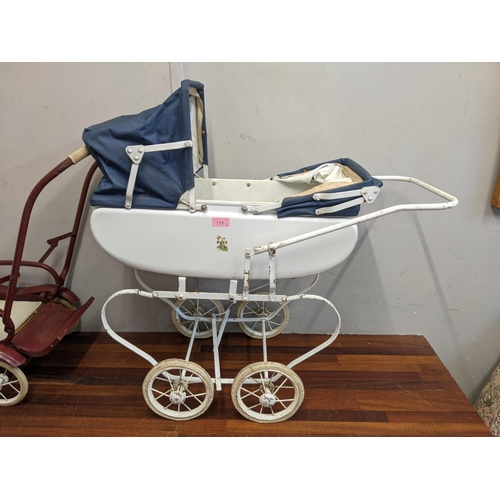 115 - Two 1960's dolls prams, one white with decoration on the side with a canopy and the other dark red w... 