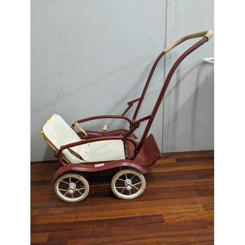 115 - Two 1960's dolls prams, one white with decoration on the side with a canopy and the other dark red w... 