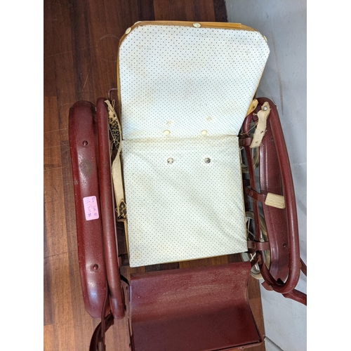 115 - Two 1960's dolls prams, one white with decoration on the side with a canopy and the other dark red w... 