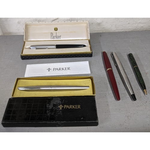 12 - A collection of pens to include a boxed Parker 51 fountain pen, a boxed Parker 41 fountain pen and t... 