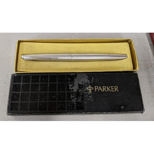 12 - A collection of pens to include a boxed Parker 51 fountain pen, a boxed Parker 41 fountain pen and t... 