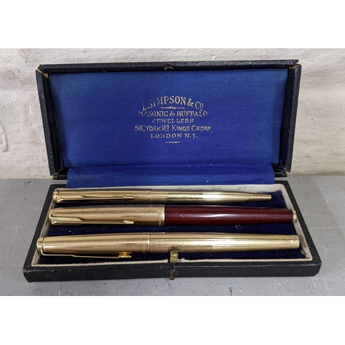 2 - Three gold coloured Parker pens in a vintage box to include two fountain pens and a roller ball pen,... 