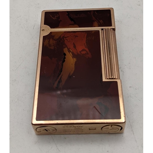 23 - A Dupont red marbled lacquered cigarette lighter in it original case and box
Location:CAB3
If there ... 