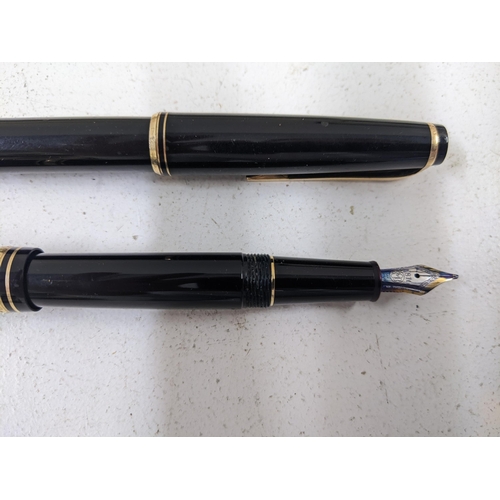 24 - Mont Blanc pens to include a boxed 4810 Fountain pen and two other unboxed fountain pens with writin... 