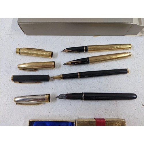 25 - Sheaffer writing equipment to include two gold plated fountain pens both with 14ct gold nibs, a dark... 