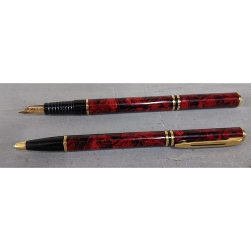 4 - Two Waterman Phiceas red pens and their original cases, to include a ballpoint pen, a fountain pen a... 