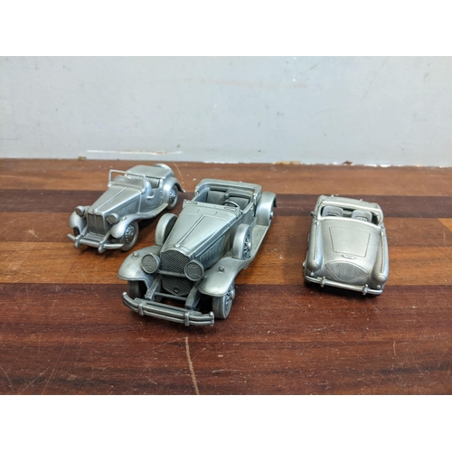 73 - A Danblry mint pewter car collection to include an Austin Healy 100, a BMW petrol tanker and No 21 F... 