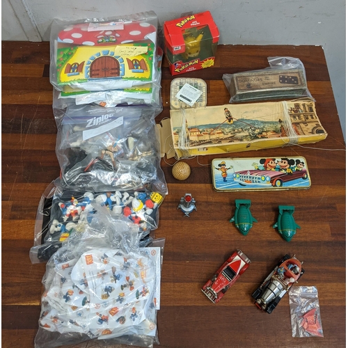 75 - A collection of toys to include Smurf related McDonalds Happy Meal toys, a Corgi toys Chitty Chitty ... 