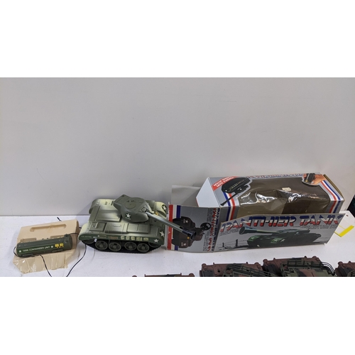 95 - A collection of remote control tanks to include Micros examples with controls and battery packs and ... 