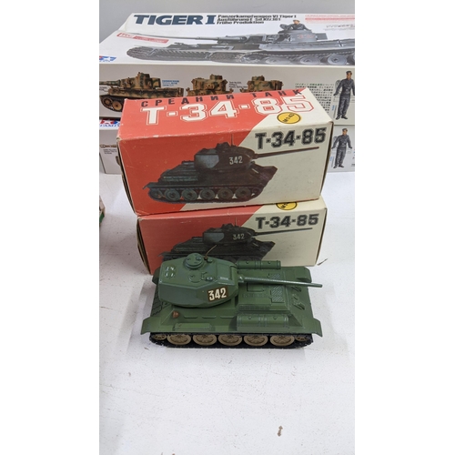 99 - Boxed model tanks to include two tamiya Tiger 1 tanks both incomplete, two Russian T-34-85's a Marx ... 