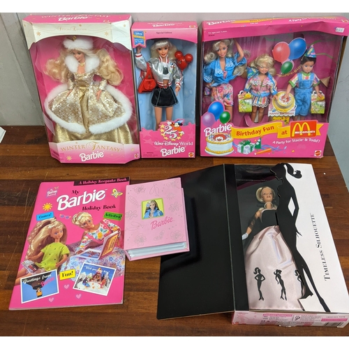 76 - A collection of boxed Barbie dolls to include limited edition winter fantasy, Walt Disney world Barb... 